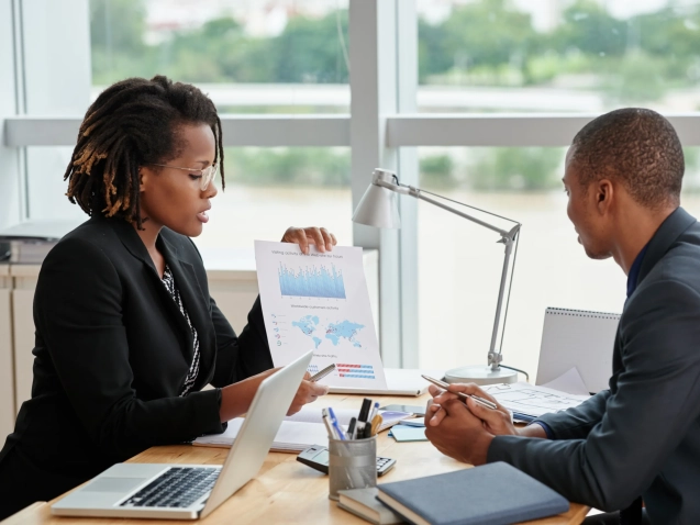 side-view-businesswoman-showing-analytical-charts-her-male-coworker